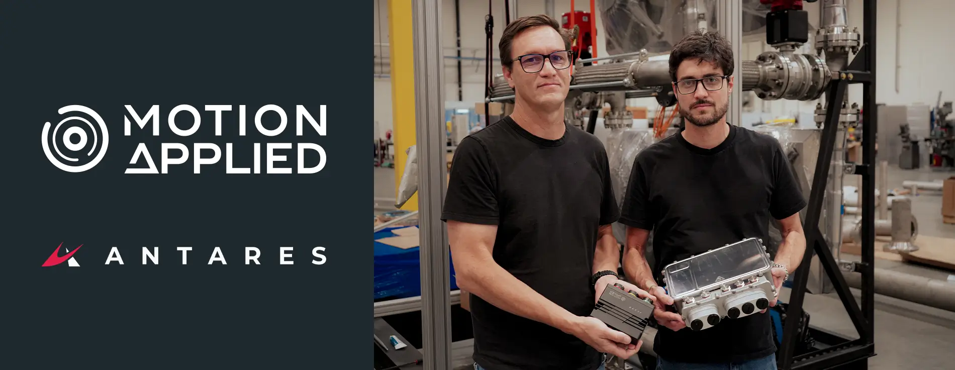 Two people holding electronic equipment in a warehouse